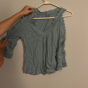 Light blue open shoulder long sleeved blouse with lace detailing